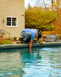 Coastal Pools technician servicing an inground pool
