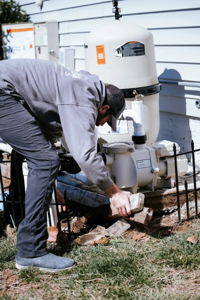 Coastal Pools technician working on pool equipment