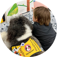 Therapy dog and child reading together