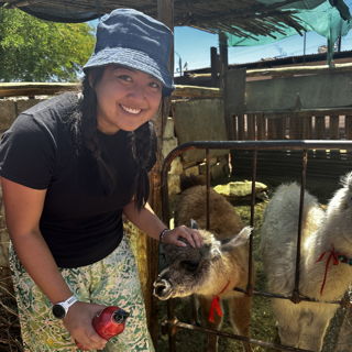 Lily posing with an alpaca in Chile.