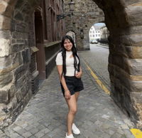 Lizbeth standing next to a historic building in Maastricht, Netherlands.