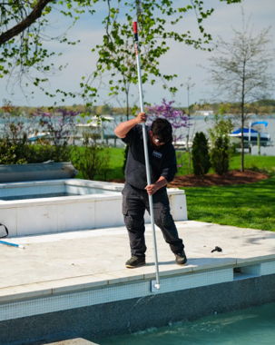 Coastal Pools technician servicing an inground pool